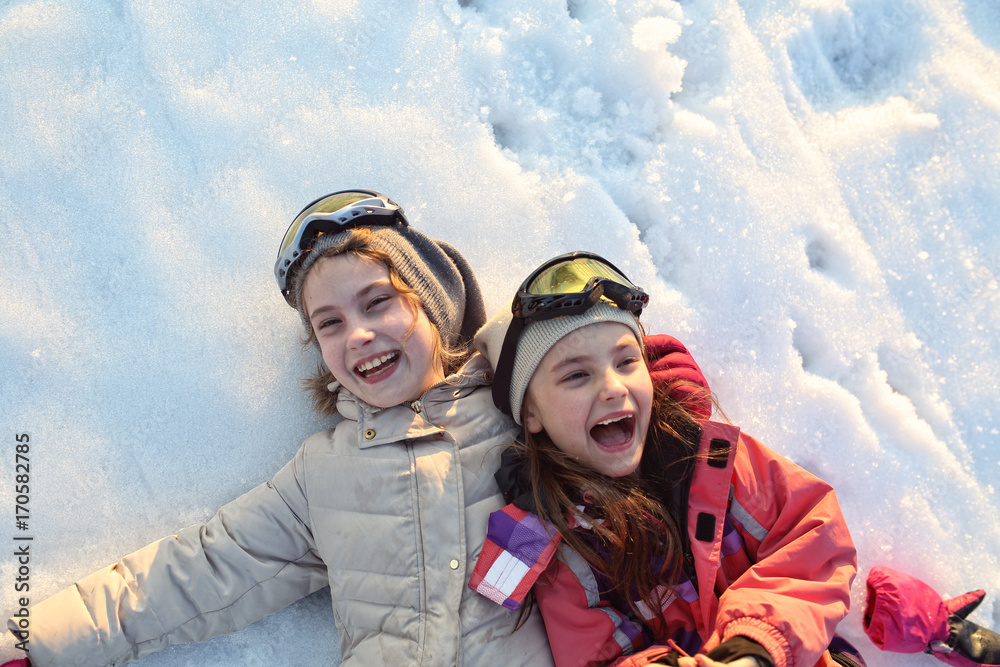 Young smiling girls play on a winter sunny day Young smiling girls play on a winter sunny day