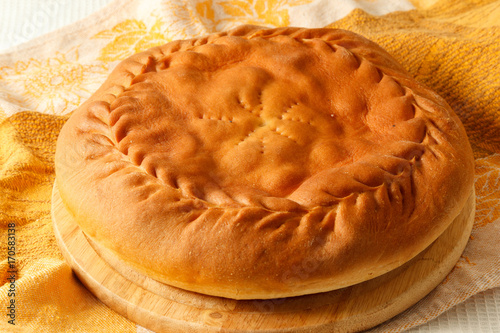 round pie with filling on a table