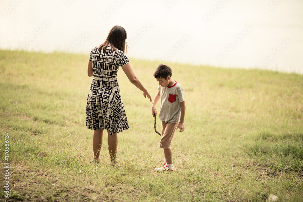 Fototapeta premium Single mother walking together in the park sunset time happiness