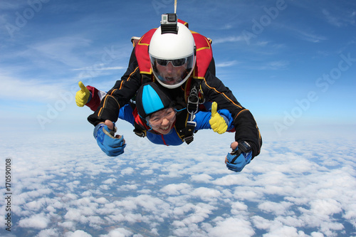 Skydiving. Tandem jump with beautiful asian girl.