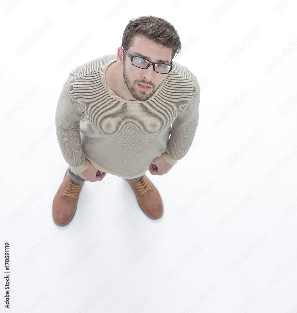 © ASDF - view from above. serious young man looking at camera.