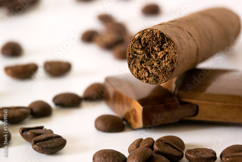 Cigar with coffee beans and lighter closeup 