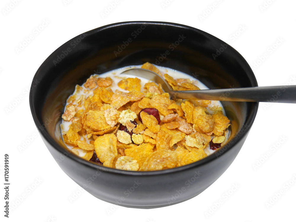 Crispy and healthy organic breakfast cereal flakes with red dried cranberry and cold soy milk in dark black handmade pottery bowl. Spoon on bowl. Isolated on white background with clipping path. Crispy and healthy organic breakfast cereal flakes with red dried cranberry and cold soy milk in dark black handmade pottery bowl. Spoon on bowl. Isolated on white background with clipping path.