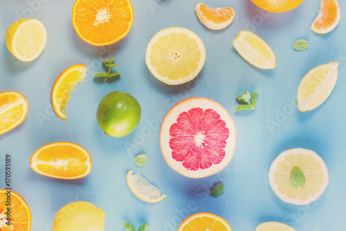 Wallpaper Mural citrus food pattern on blue background - assorted sliced citrus fruits with mint leaves, retro toned Torontodigital.ca