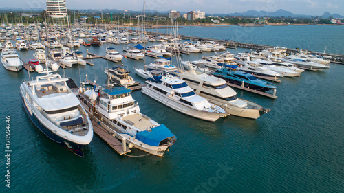 Pier speedboat. A marina lot. This is usually the most popular tourist attractions on the beach.Yacht and sailboat is moored at the quay.Aerial view by drone.Top view. © MAGNIFIER