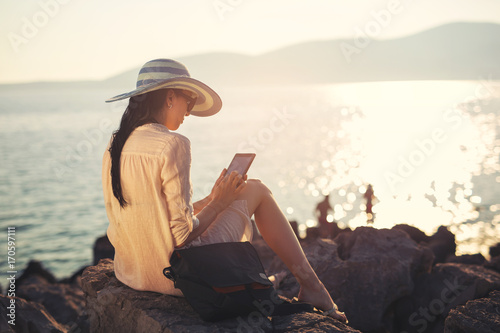 Woman using digital tablet on the sea