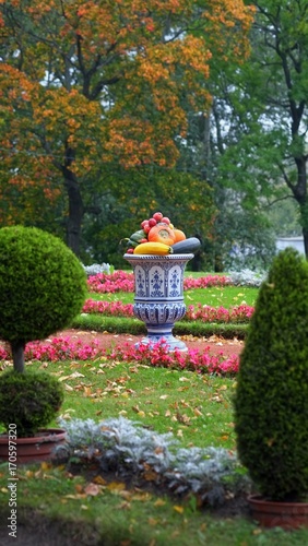 Fototapeta Naklejka Na Ścianę i Meble -  Autumn park and earthenware Chinese vase with vegetables