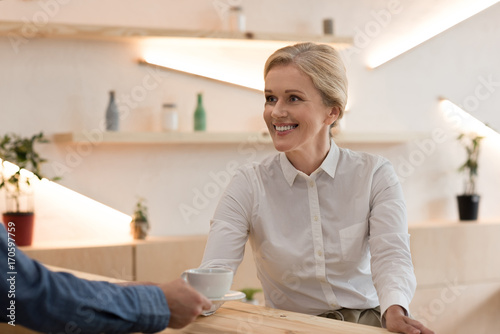 barista giving order to woman