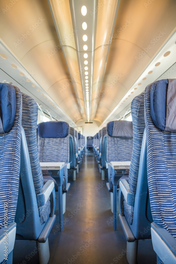 Fototapeta premium Empty rail passenger carriage seat rows with dimishing perspective