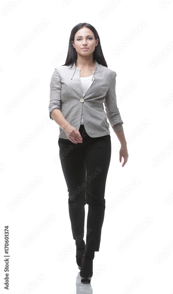 In full growth. The modern young woman confidently goes forward. In full growth. The modern young woman confidently goes forward.
