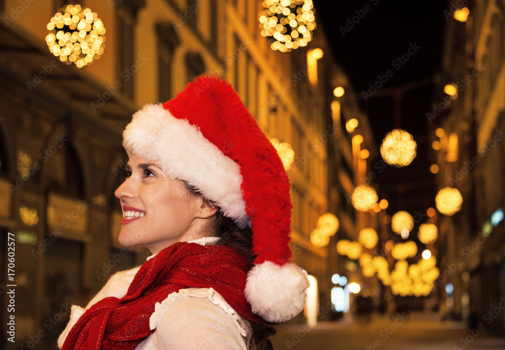 happy modern woman in Christmas hat in Florence, Italy happy modern woman in Christmas hat in Florence, Italy