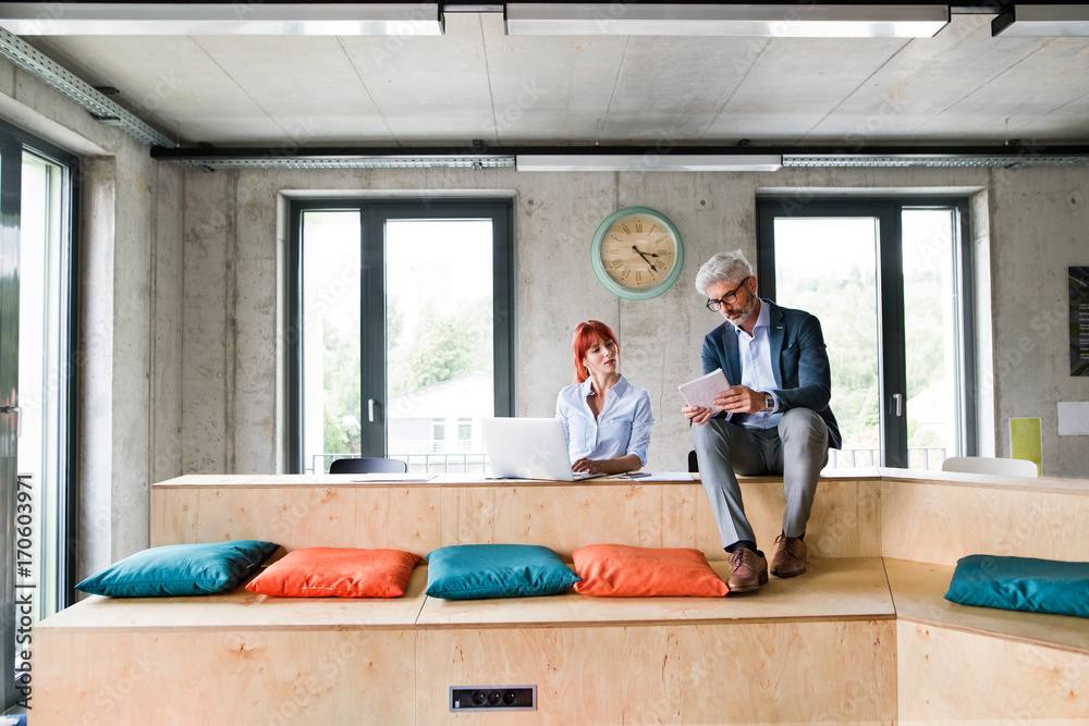 Business people in the office consulting a project. Business people in the office consulting a project.