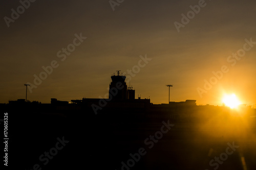 Air Traffic Control Tower at the airport during amazing sunset.