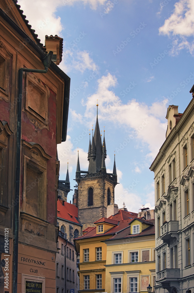 Prague, The Czech Republic: 21 AUGUST 2017- Winding streets of old Prague. Beautiful tower of the Church of Our Lady before Týn rises above the vintage small houses. 