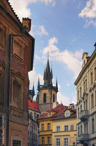 Prague, The Czech Republic: 21 AUGUST 2017- Winding streets of old Prague. Beautiful tower of the Church of Our Lady before Týn rises above the vintage small houses. 