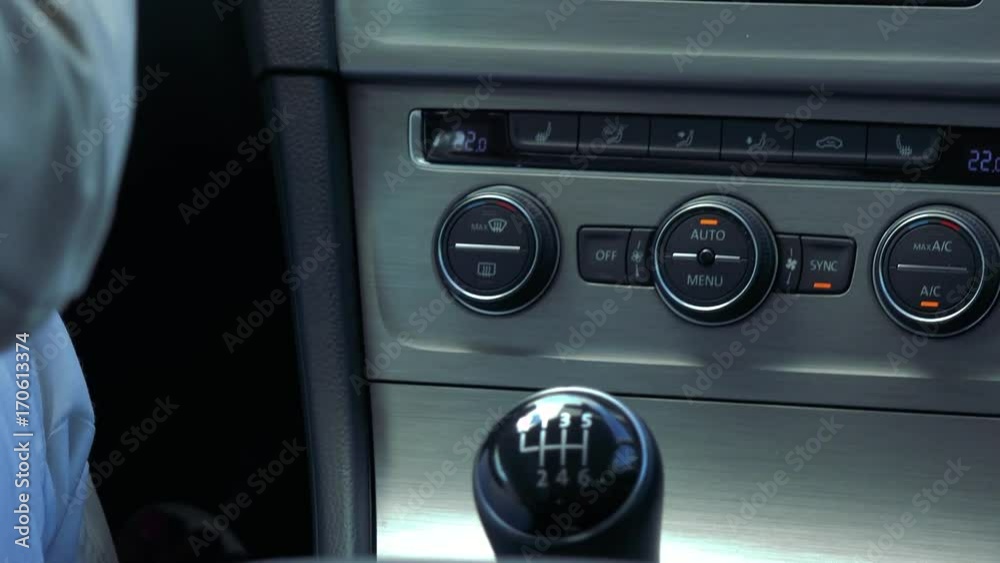 Middle aged woman drives a car and shifting - closeup of manual gearbox Middle aged woman drives a car and shifting - closeup of manual gearbox