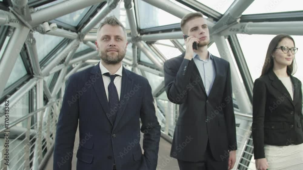 team of three businessmen in business center team of three businessmen in business center