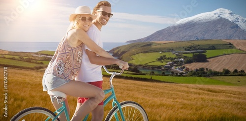 Composite image of cute couple on a bike ride digital composite