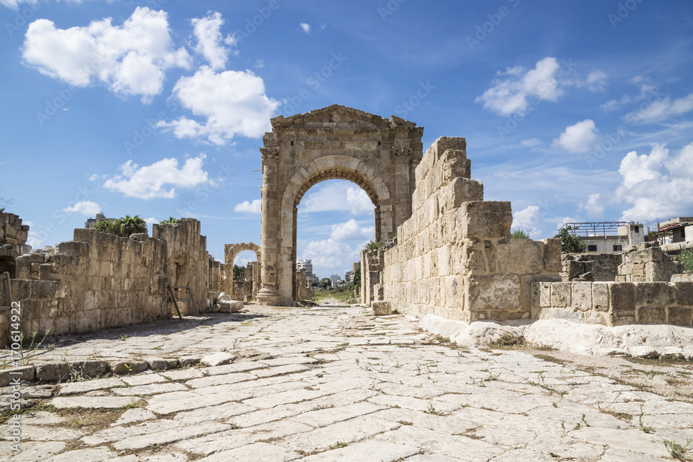 Al-Bass, Byzantine road with triumph arch with blue sky and clouds in ruins of Tyre, Lebanon
