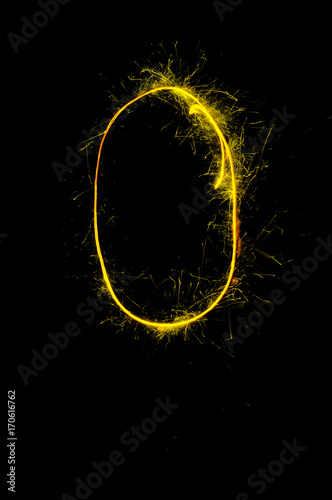"0" number drawn with bengali sparkles isolated on black background,number from sparkler on black background