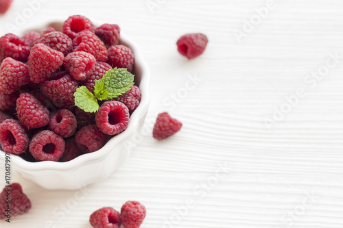 Plate with raspberries on a table