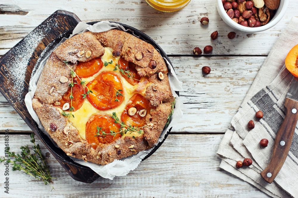 Apricot wholegrain galette with cream cheese filling and roasted almond. Fruit tart. Overhead view Apricot wholegrain galette with cream cheese filling and roasted almond. Fruit tart. Overhead view