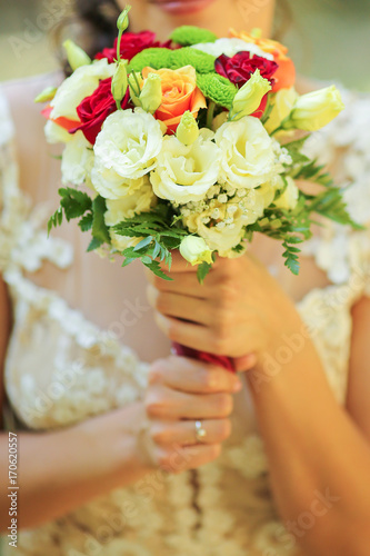 close up of bride holding flowers