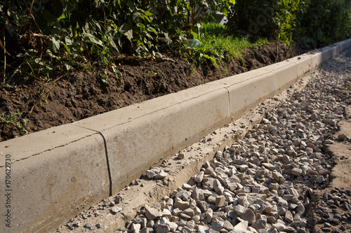 Sidewalk under construction, concrete curb  installation in progress.