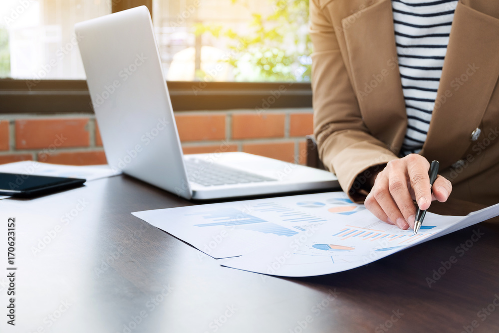close up business executive working with laptop an data documents in formal uniform at the office close up business executive working with laptop an data documents in formal uniform at the office