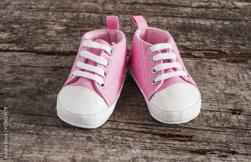 Baby shoes on wooden background