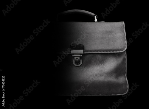 Expensive leather briefcase on a black background.