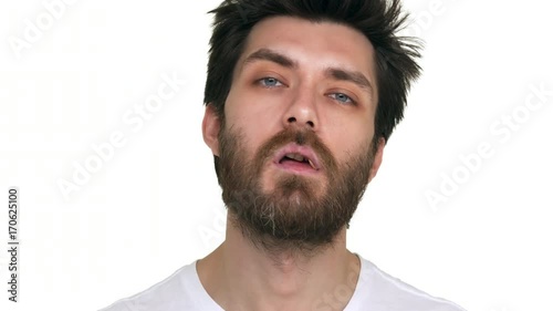 Young bearded man with a toothpick in mouth acting loose on white background photo