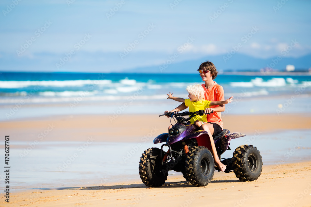 Obraz premium Kids on quad bike. Off road all terrain vehicle.