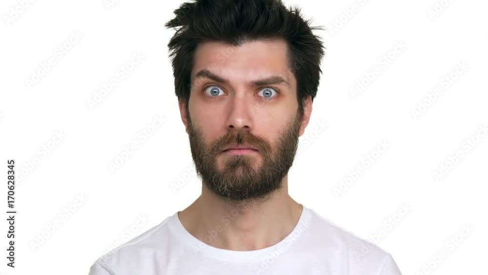 Bearded man moving eyebrows looking straight confident playful on white background Bearded man moving eyebrows looking straight confident playful on white background