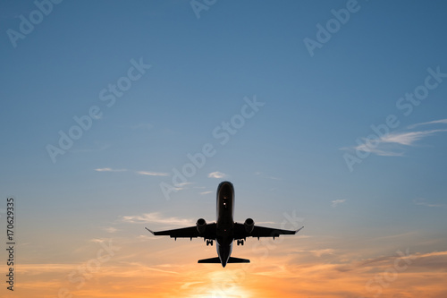 airplane on sunset sky , aircraft silhouette scenic sky