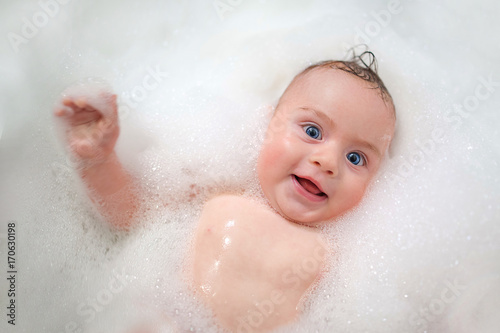 baby bathing in foam