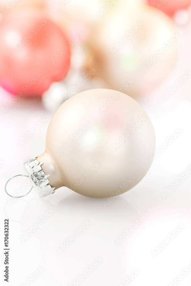 White and red Christmas balls scattered on light background. High key image. Template for greeting card, poster, banner, invitation. Clean minimalist style. White and red Christmas balls scattered on light background. High key image. Template for greeting card, poster, banner, invitation. Clean minimalist style.