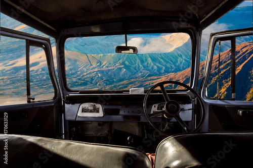 View on the dashboard of the car. Bromo mountains is in front of the car. © Khritthithat
