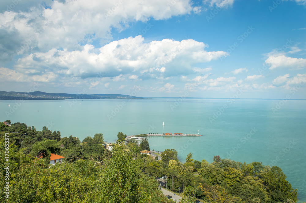 Beautiful view of Lake Balaton, from Tihany village in Hungary, with blue sky and clouds, summer colors in the foreground