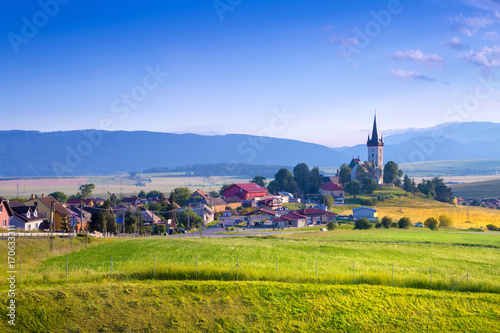 Fotografi Beautiful landscape of valley in Slovakia mountains, small houses in village, rural scene