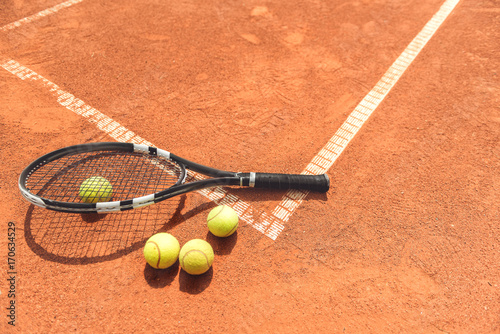 Racquet beside round objects on court © Yakobchuk Olena