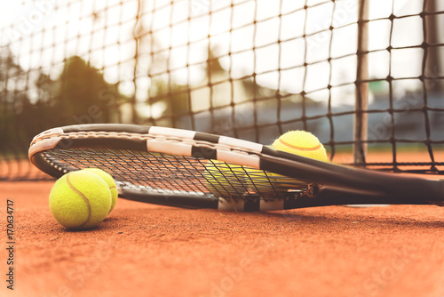 Necessary tennis equipment near net © Yakobchuk Olena