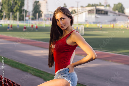 Young woman posing at local stadium
