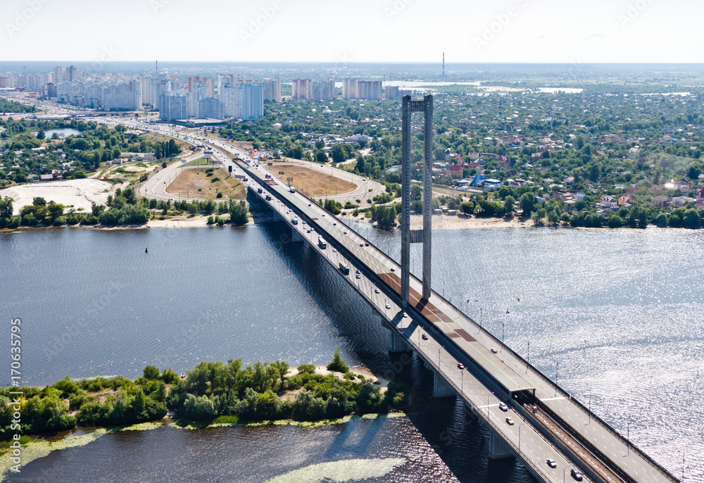 Aerial view of the Kiev (Kyiv) city, Ukraine. Dnieper river with combined car and subway bridge. South bridge. Housing estate Osokorki in the background