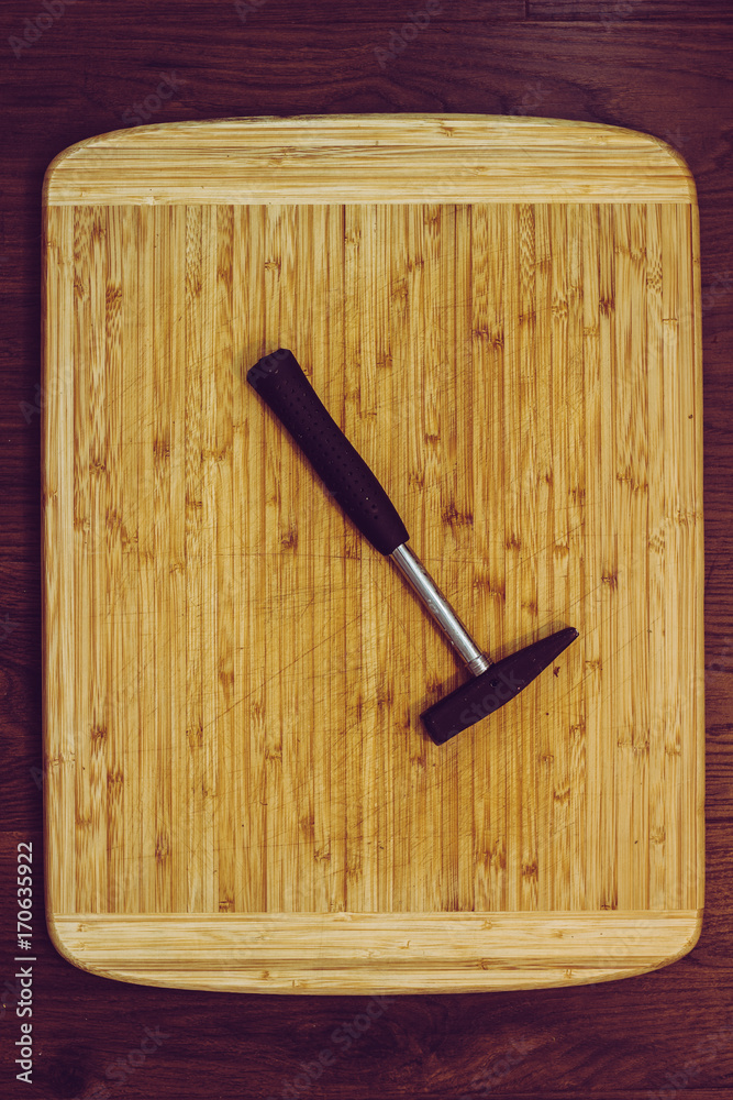 wooden kitchen cutting board with hammer and tools