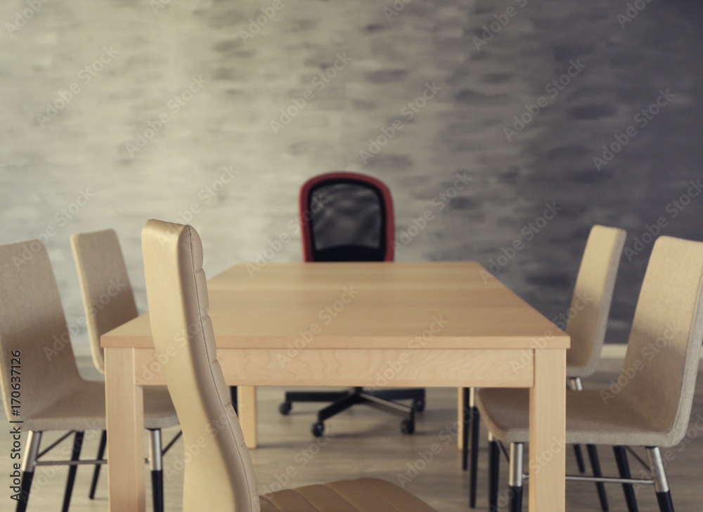 Empty wooden table and chairs in conference room