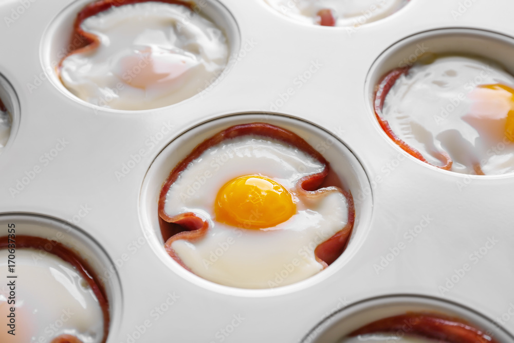 Muffin tin with tasty eggs and ham, closeup Muffin tin with tasty eggs and ham, closeup
