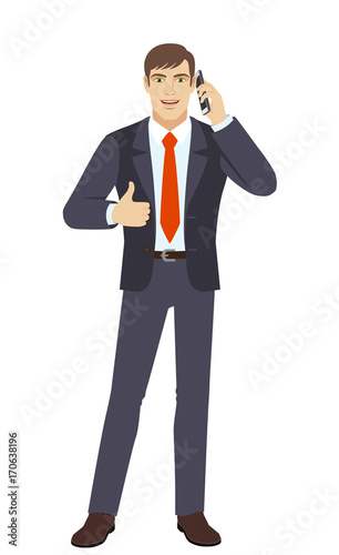  Businessman talking on the mobile phone and showing thumb up © komissar007