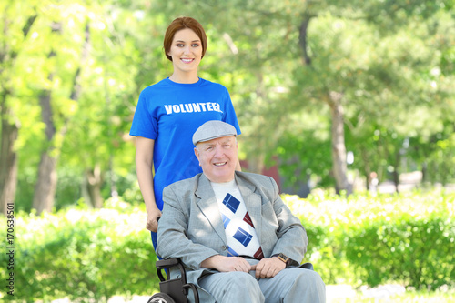 Happy senior man on wheelch...