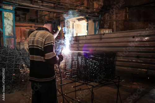 Specialist performing welding in factory workshop © Africa Studio